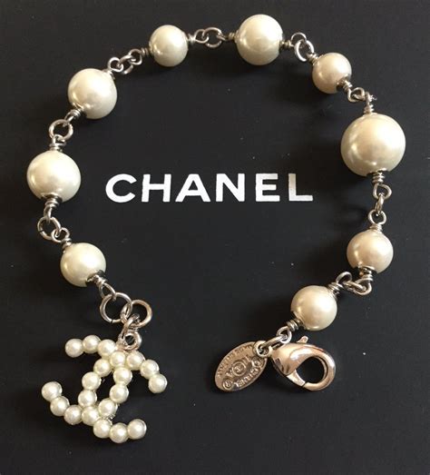 chanel silver metal strap.